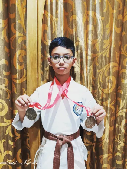 Believing in yourself is the first step to success. This brown belt student proudly displays the medals he earned through his dedication and strong belief in his abilities.