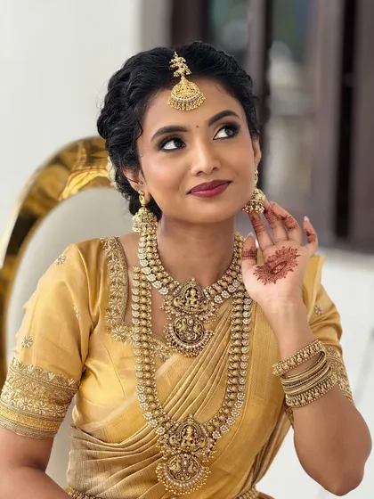 A beautiful candid shot of my bride Anju, showcasing her traditional South Indian bridal look with intricate temple jewelry.