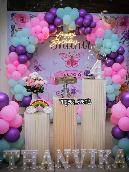 A butterfly and rainbow-themed 4th birthday party. The pastel colors and cute rainbow light add a touch of magic.