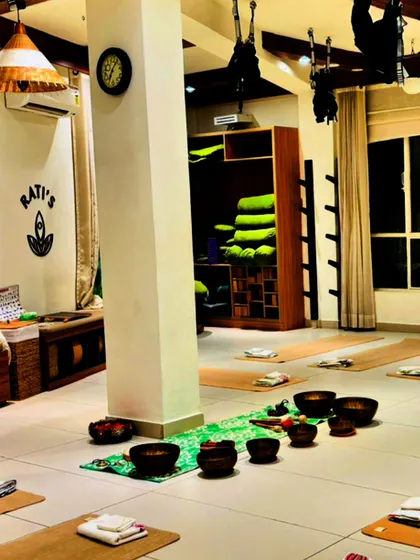 The studio prepared for a sound healing session, with singing bowls placed carefully on each mat, ready to create a symphony of healing vibrations.