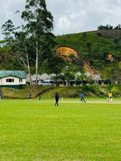 A match in progress at a picturesque cricket ground in the hills of Sri Lanka.