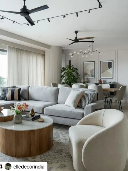 The open-plan living and dining area of the Neutral Chic home, as featured in Elle Decor. The space is a tapestry of monochromatic elegance, designed as a minimalist haven.