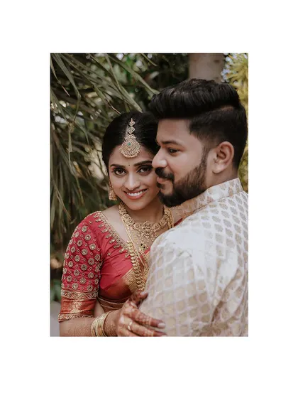 A sweet and intimate portrait of a couple, with the bride looking over the groom's shoulder.