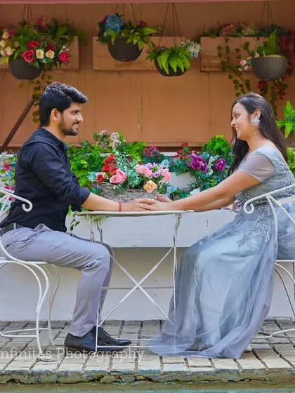 A romantic hand-hold across the table at our European-style cafe set, surrounded by flowers for a charming and intimate portrait.