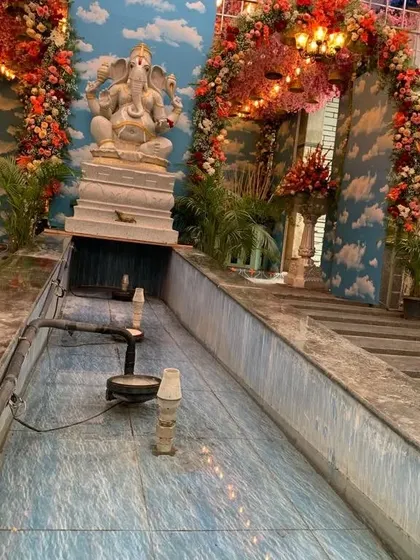 A view of the water feature and Ganesha statue at the grand naming ceremony venue. My decorations are designed to complement and enhance the existing architecture of the space.
