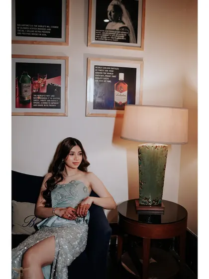 Another beautiful portrait of the bride-to-be, capturing a moment of quiet elegance amidst the party atmosphere. The soft lighting and thoughtful expression create a stunning image.