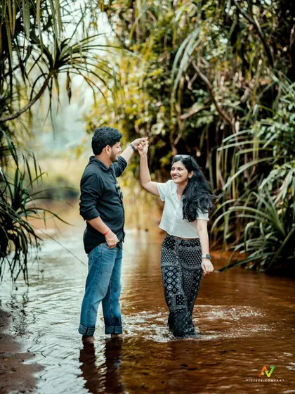 A romantic dance in a gentle stream, surrounded by lush greenery, capturing a beautiful, natural moment.