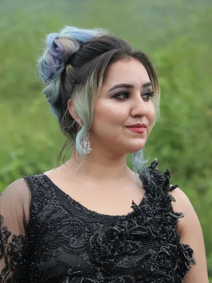 Our training covers modern glamour and hairstyling too. This look, created by a student, features a soft glam makeup with a trendy, colorful hair updo, perfect for fashion shoots and events.