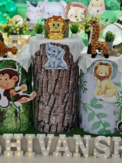 Themed pedestals are a key part of my designs. For Shivansh's party, I used pedestals with tree bark and leaf patterns, topped with light-up letters spelling his name and cute animal figures.