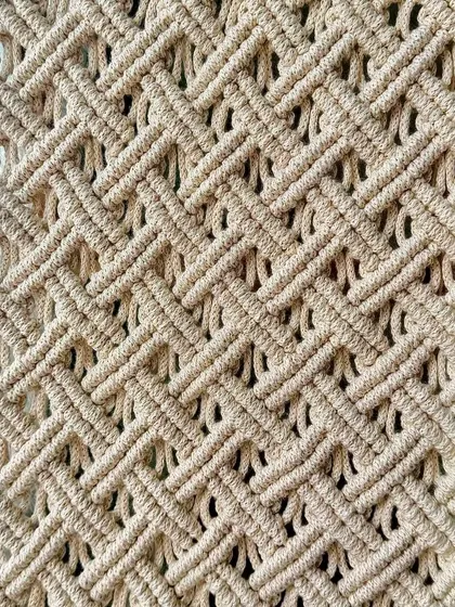 It's all in the details. This close-up shows the texture and warmth that a handmade macrame piece can bring to your home decor.