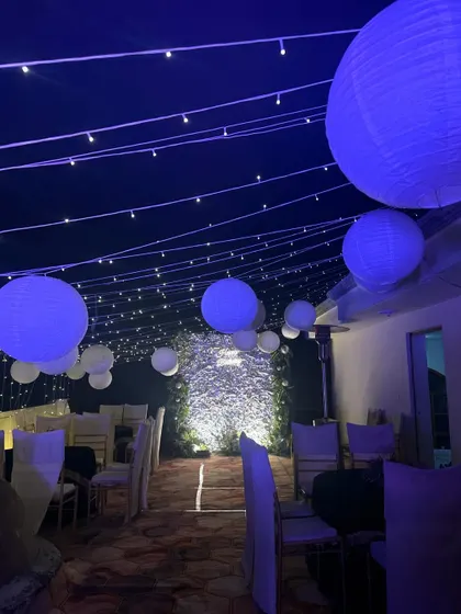 We transformed this rooftop with a canopy of fairy lights and hanging paper lanterns, creating a magical and dreamy atmosphere for a birthday celebration.
