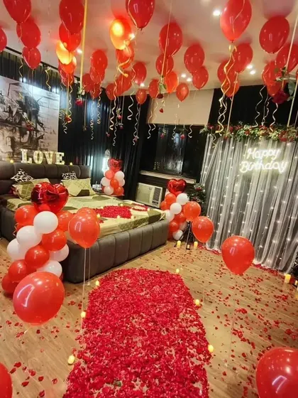 A wide-angle view of our ultimate romantic room setup, showing the rose petal pathway, balloon-filled room, and glowing "Happy Birthday" sign.