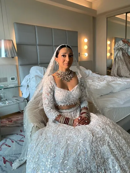 The bride, ready and waiting. Her sleek bun ensures she looks polished and photo ready from every angle, even in candid moments before the ceremony.