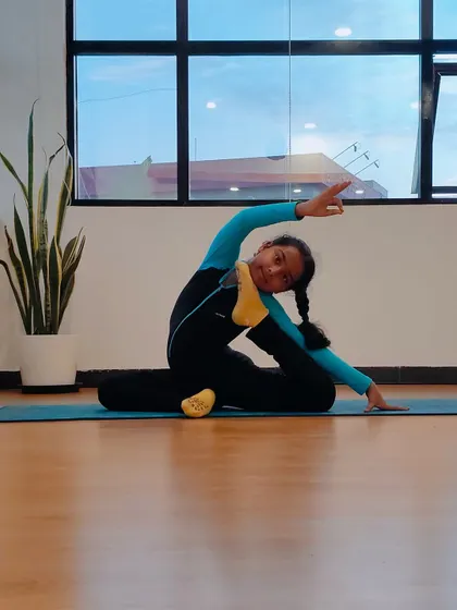 Charvi demonstrates a beautiful variation of the Mermaid Pose, showcasing her incredible flexibility and poise. Her transformation continues to inspire our entire community.
