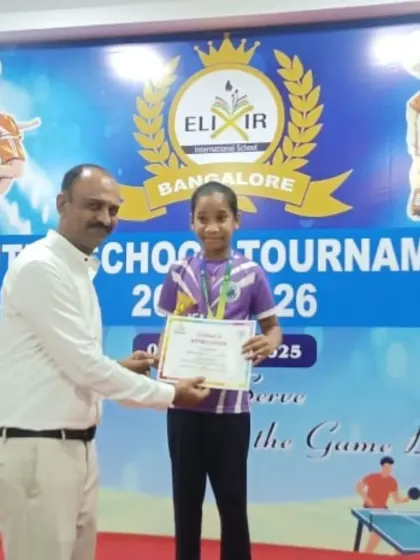 A rising star is honored. Jashira Reddy P receives her certificate and medal for winning Gold in the U10 Girls Singles at the Elixir Inter-School Tournament.
