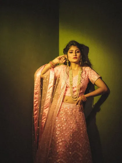 Playing with colored gels to create a specific mood. The sharp shadow and the green-yellow light give this fashion portrait an edgy, high-fashion feel, transforming the corner of a room into a studio set.