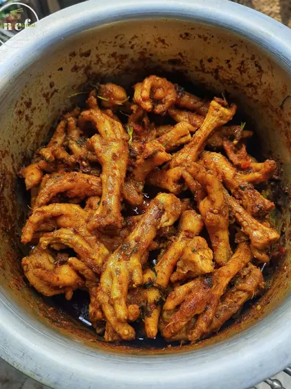 A bowl of chicken feet stir-fry, a savory and popular snack in Manipur.