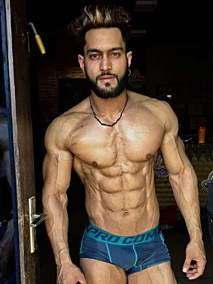 A close-up look at upper body conditioning. The details matter, from a defined chest to shredded abs and vascular arms.
