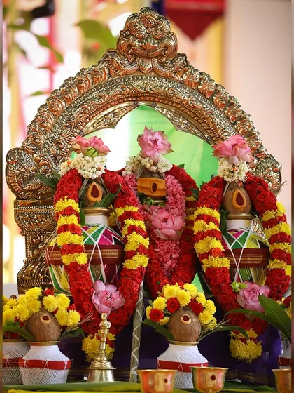 A close up of the decorated kalashas for the Navagraha Homa. Each pot is adorned with flowers and represents one of the nine celestial bodies in Vedic astrology.