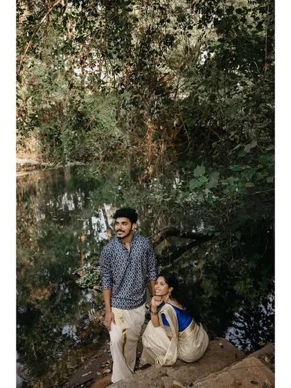 A serene portrait of a couple by a pond, enjoying the tranquility of nature.
