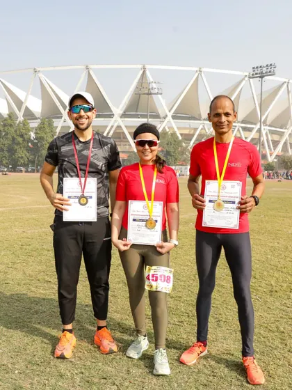 Three of our runners proudly displaying their medals after competing in a 10,000-meter Masters Meet. We came away with two golds and a bronze.
