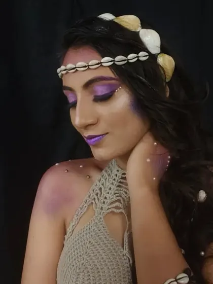 A serene portrait of the mermaid look, highlighting the soft purple contouring and pearl embellishments on the skin.
