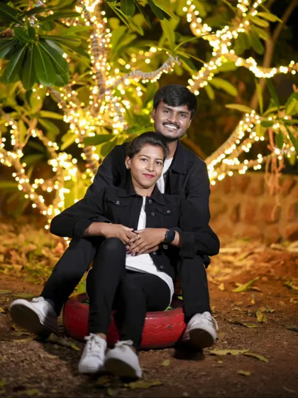 A sweet moment captured under a tree decorated with fairy lights. Night shoots offer a unique and magical atmosphere.