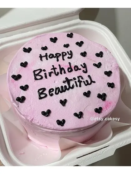 A pretty pink bento cake with the message "Happy Birthday Beautiful" and black hearts.