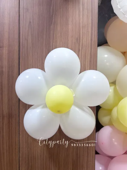 A close-up of a daisy flower balloon we crafted from simple white and yellow balloons. These custom shapes can be added to any arrangement to match your theme.
