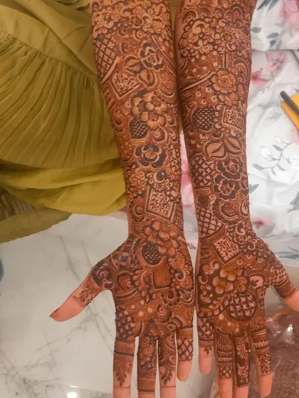 A full coverage bridal design with a mix of floral and geometric patterns. The density of the design ensures a stunning and impactful look.