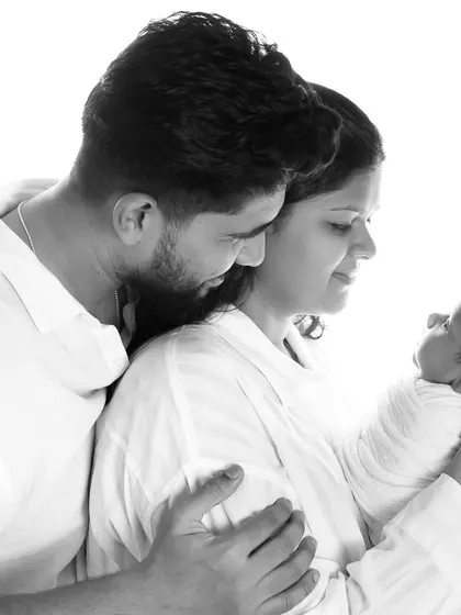 A tender moment between new parents as they gaze at their baby. These high-contrast, black and white photos are memories to last forever.