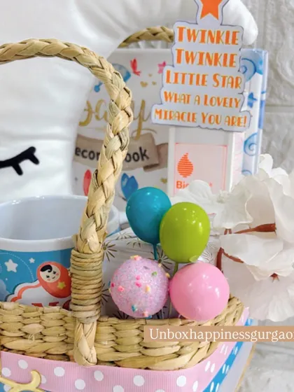 This angle shows the "Twinkle Twinkle Little Star" card and other decorative elements that make this moon-themed hamper a magical gift for expecting parents.