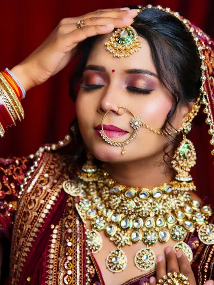 A beautiful close-up of a bridal look, focusing on the warm-toned eyeshadow and the intricate kundan jewelry. This is a result of dedicated practice in our studio.