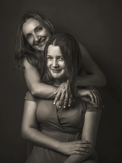 The joy in this mother-daughter portrait is palpable, and the black and white edit makes it feel classic and timeless. The focus is on their connected smiles and the warmth of the embrace, a beautiful memory preserved forever.