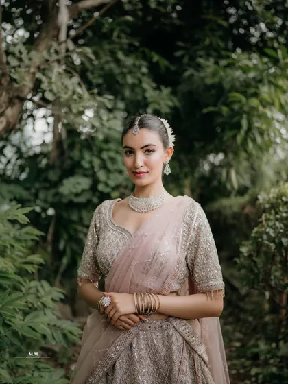 A classic and elegant portrait. The bride's direct gaze and poised stance exude confidence and grace.