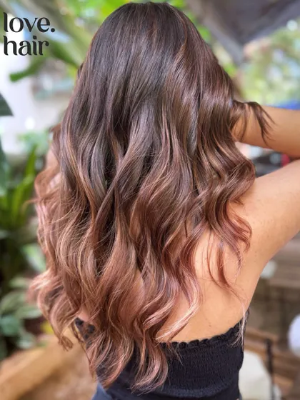A closer look at the blush balayage, showing the delicate blend of rose gold tones into the brunette base.