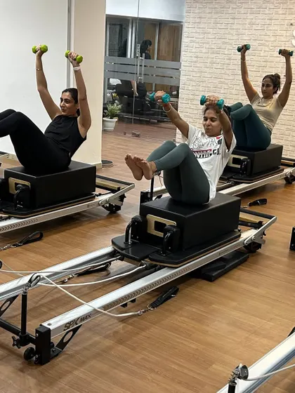 Various shots of members and instructors in action during our dynamic Reformer Pilates classes.