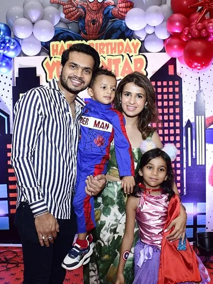 A beautiful family photo in front of the custom Spider-Man backdrop I designed. These are the moments they'll cherish forever.