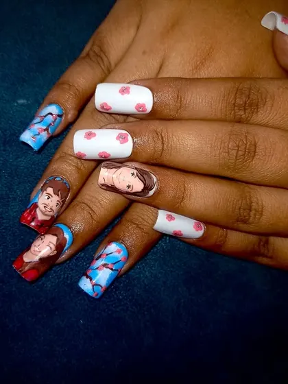 A full view of the Ghibli-style custom portrait nails being worn. The set combines personalized portraits with delicate floral patterns.