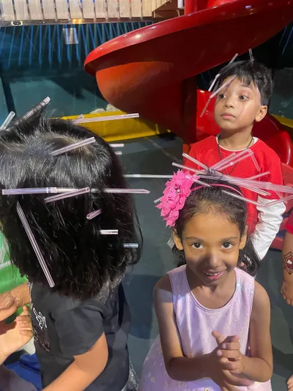 More fun with the straw-hair game. The kids are getting creative and enjoying the friendly competition.