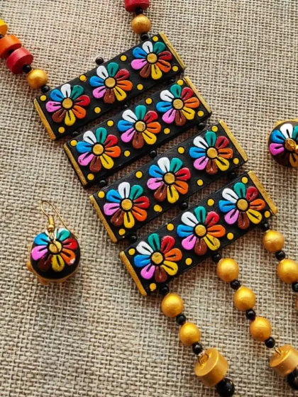 A different angle of the rectangular floral necklace, showing the dangling beads at the bottom. This piece comes with small, matching jhumkas.