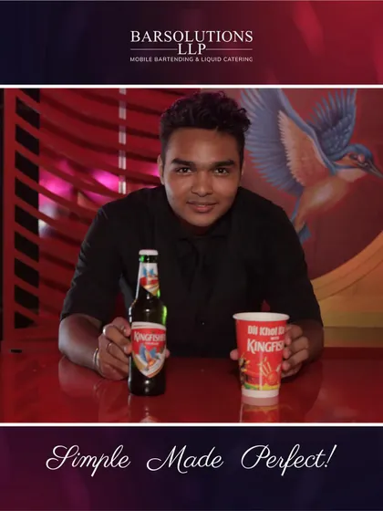 One of our professional mixologists at a Kingfisher bar, showcasing the artistry and creativity we bring to every event.