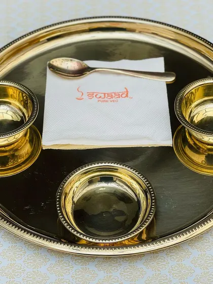 A closer look at the place setting for my Royal Thali service. The polished gold plates and bowls are ready to be filled with a delicious, premium North Indian vegetarian menu.