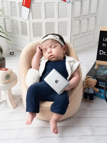 We have a tiny doctor in the house. This fun career-themed shoot for a newborn includes a mini laptop, medical books, and a stethoscope.