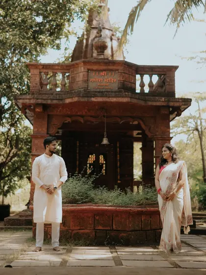 A moment of quiet connection in front of a beautiful, traditional temple in Alibaug. This pre-wedding shot blends love with a sense of divine blessing.