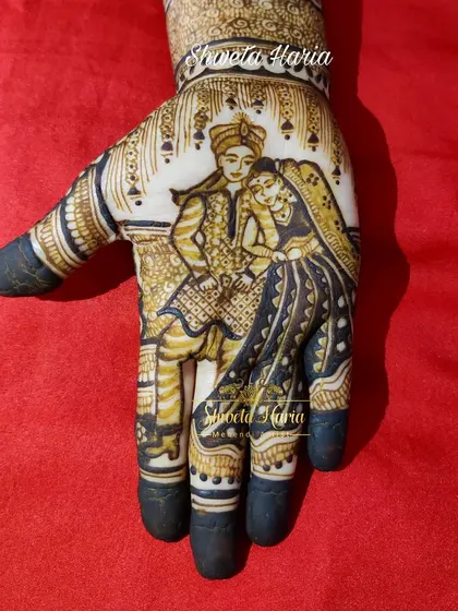 A close-up of a traditional couple portrait, showcasing the detail in the bride and groom's attire and expressions.