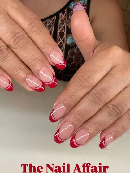 A modern twist on a classic. This double French manicure uses a bold red and clean white lines on a natural base for a chic and sophisticated look.