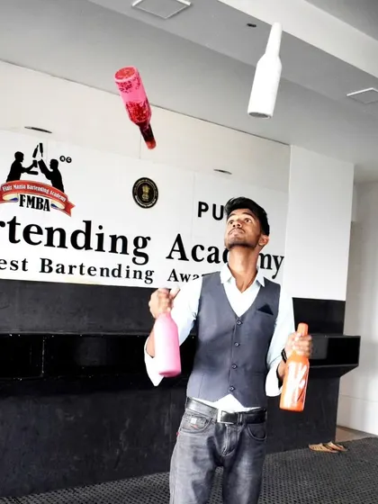 Capturing the peak of the action, our flair bartenders masterfully juggle multiple bottles. It's a display of precision and practice that elevates any party.