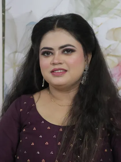 A classic portrait of the finished party look. The makeup enhances her features without being overpowering, perfect for any special occasion.