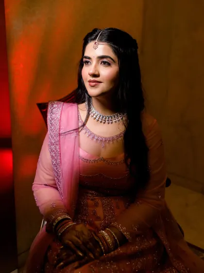 A beautiful portrait of the bride, her face illuminated by warm, soft light. Her gentle expression and elegant attire make for a timeless and graceful image.